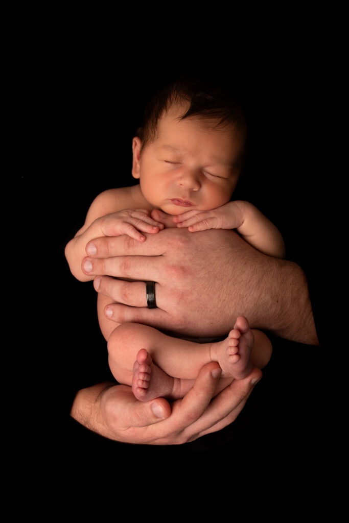newborn baby boy in daddy's hands