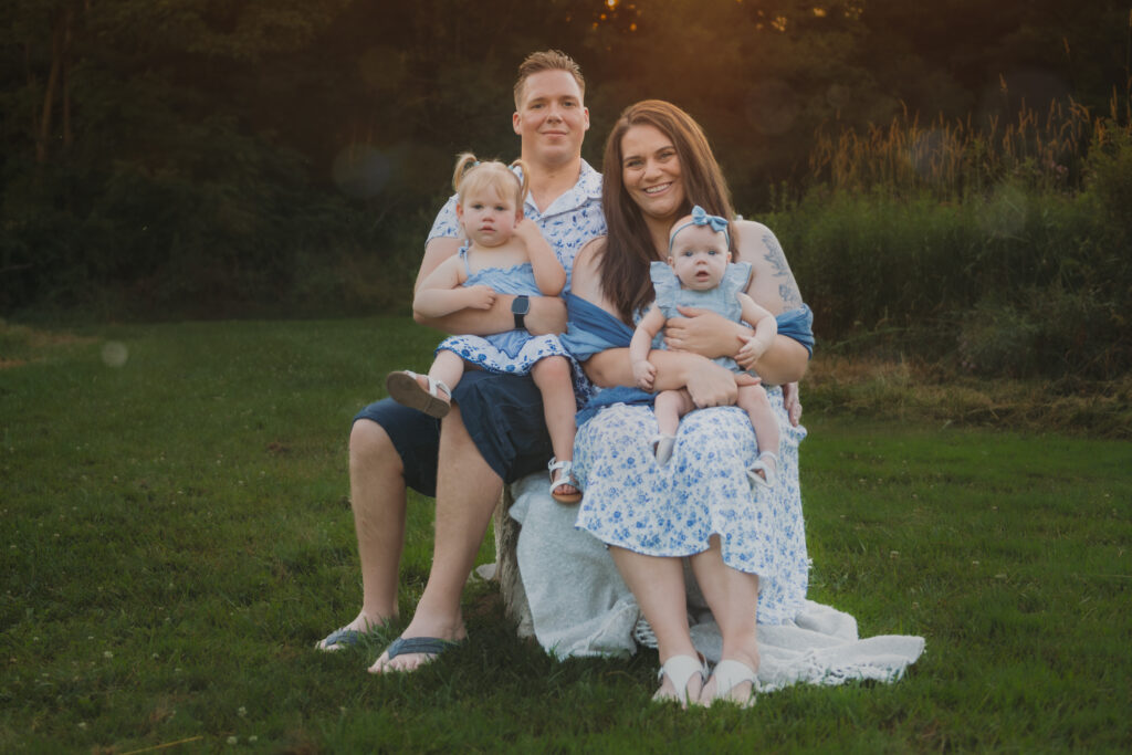 parents and children posing in a park at sunset for family pictures
