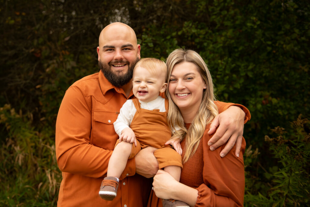 family posing for outdoor fall picture