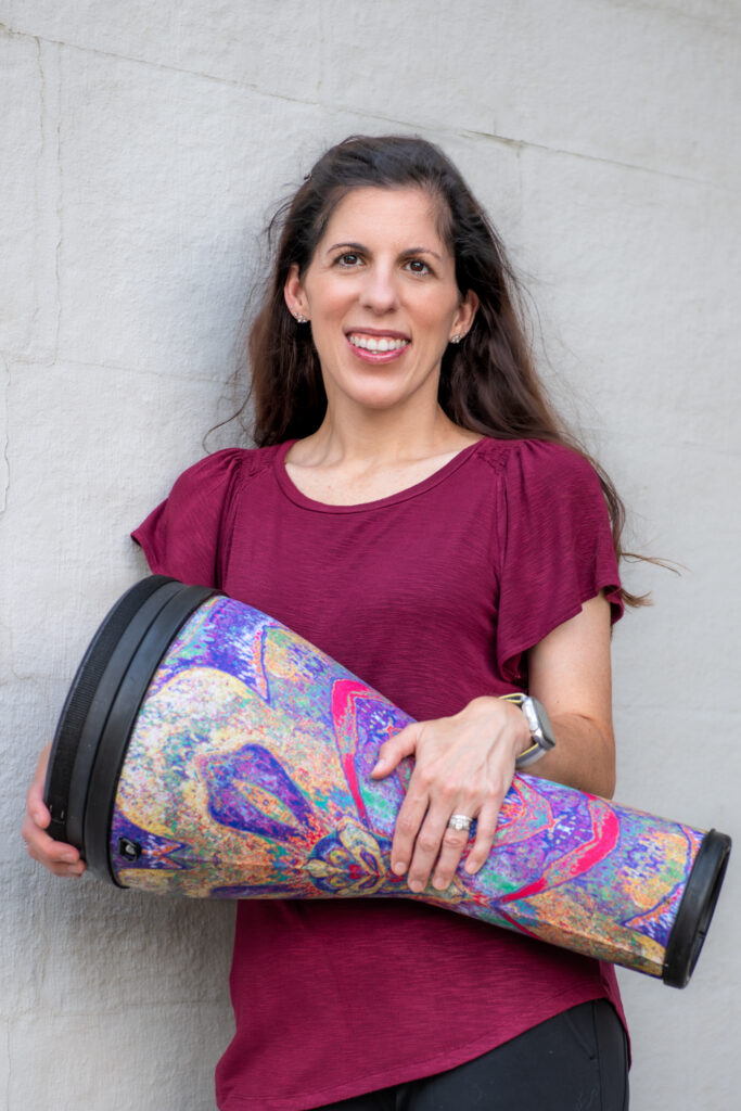 Cleveland musician posing outdoor for headshot with drum