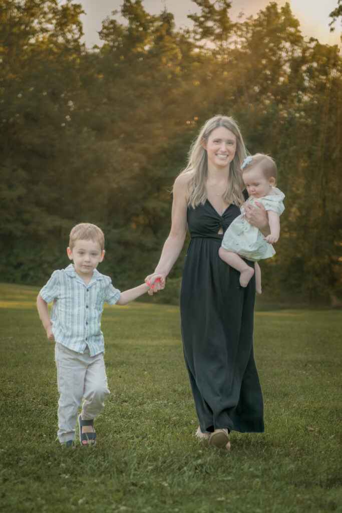 family walking outdoors in sunlight for family picture