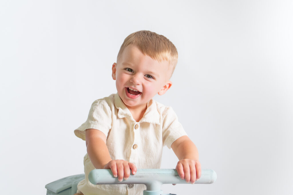 happy boy smiling riding a train photography session