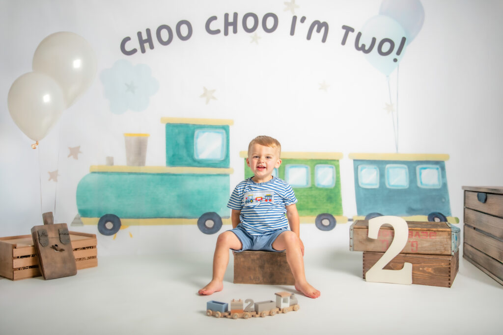 two year old photography milestone session trains and balloons