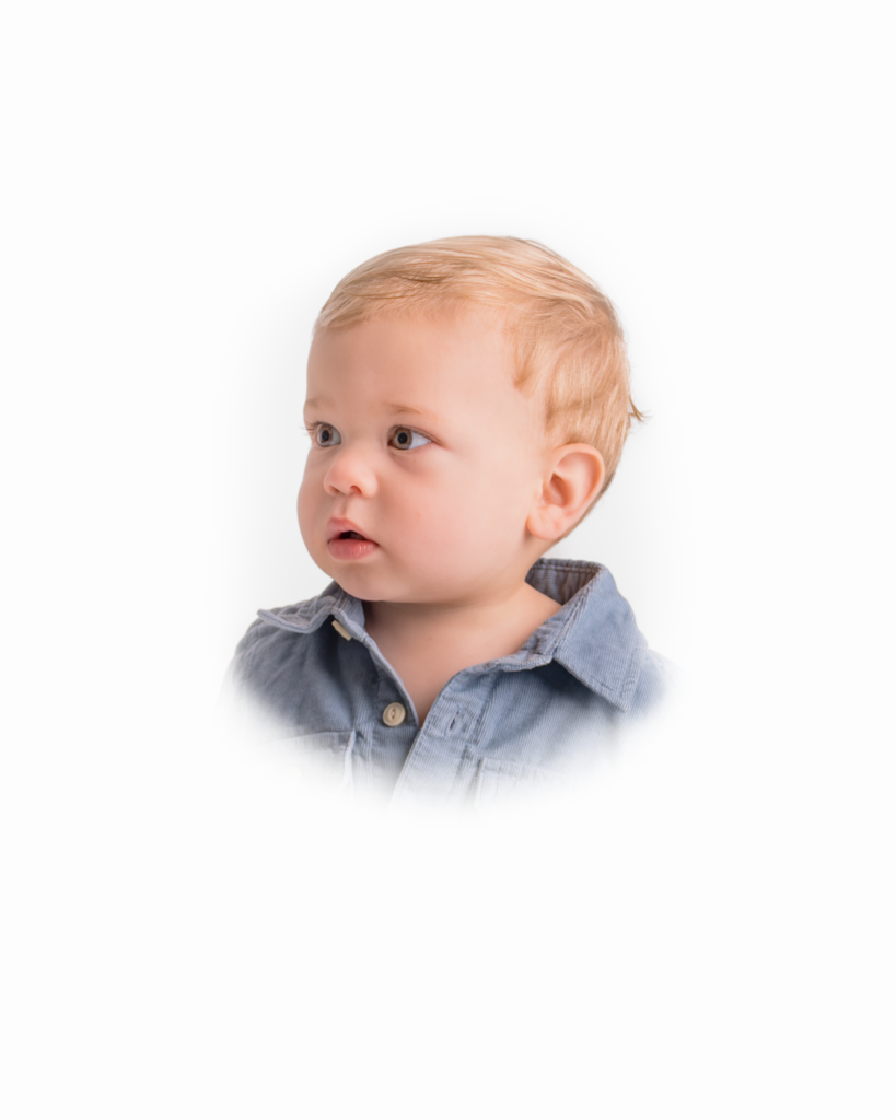 side profile of baby boy wearing a collared shirt posting for portrait