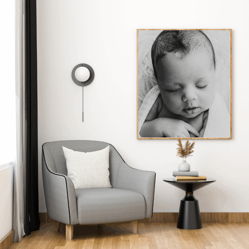 framed artwork of newborn baby girl in living room