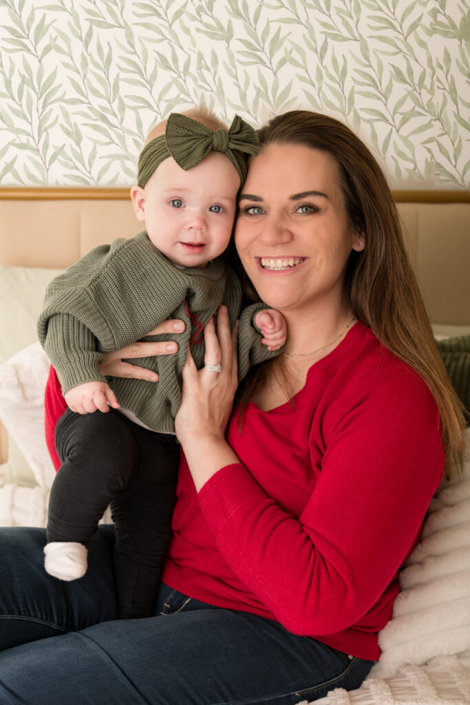 mom and baby daughter together in studio for picture cheek to cheek